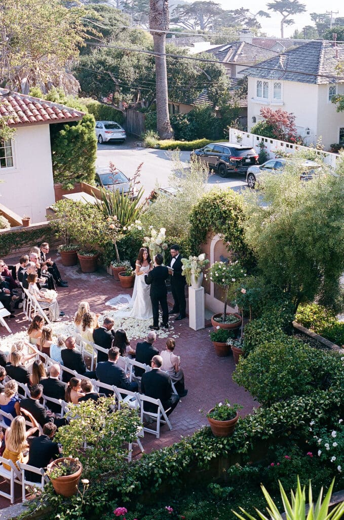 picture of the bride and groom holding hands during their ceremony 