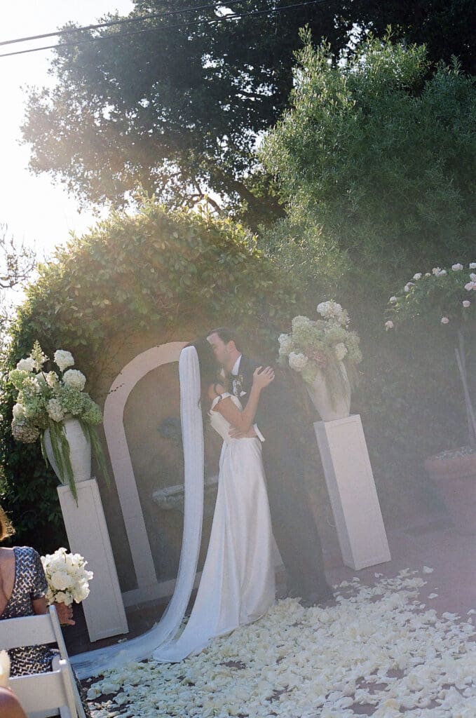bride and groom kissing after their wedding ceremony