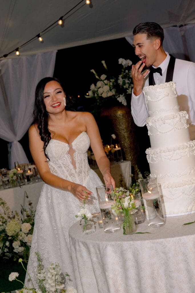 cute picture of the bride and groom cutting their wedding cake