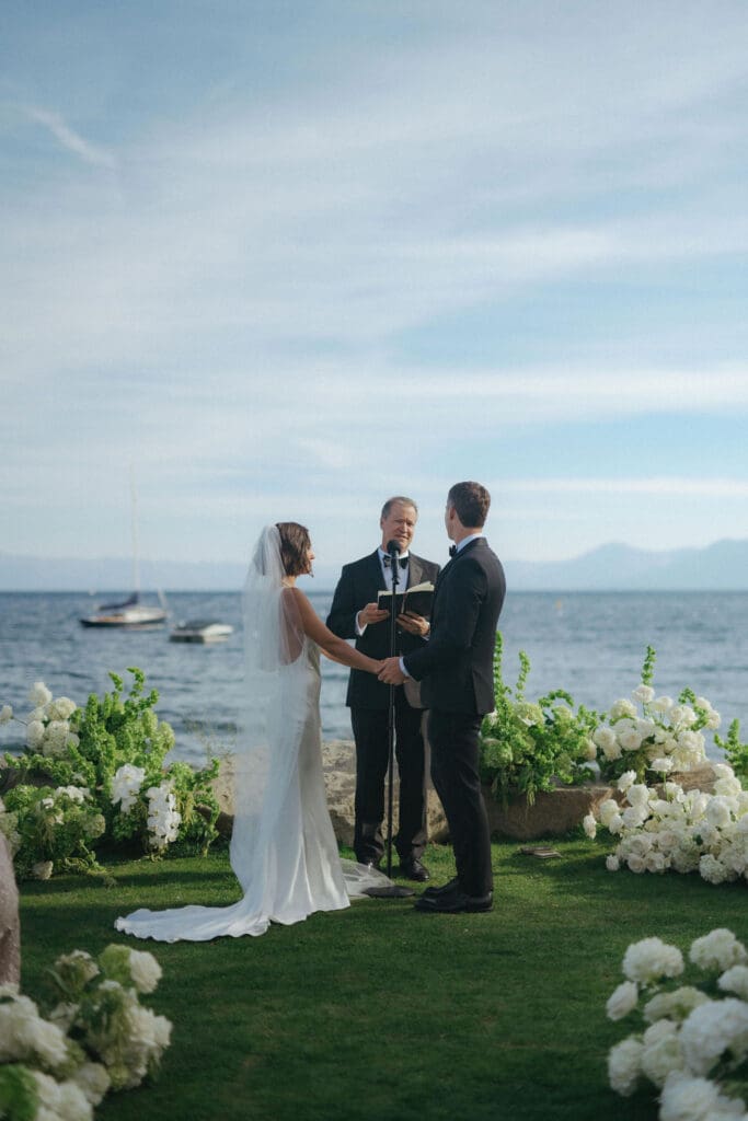 bride and groom holding hands during their wedding ceremony
