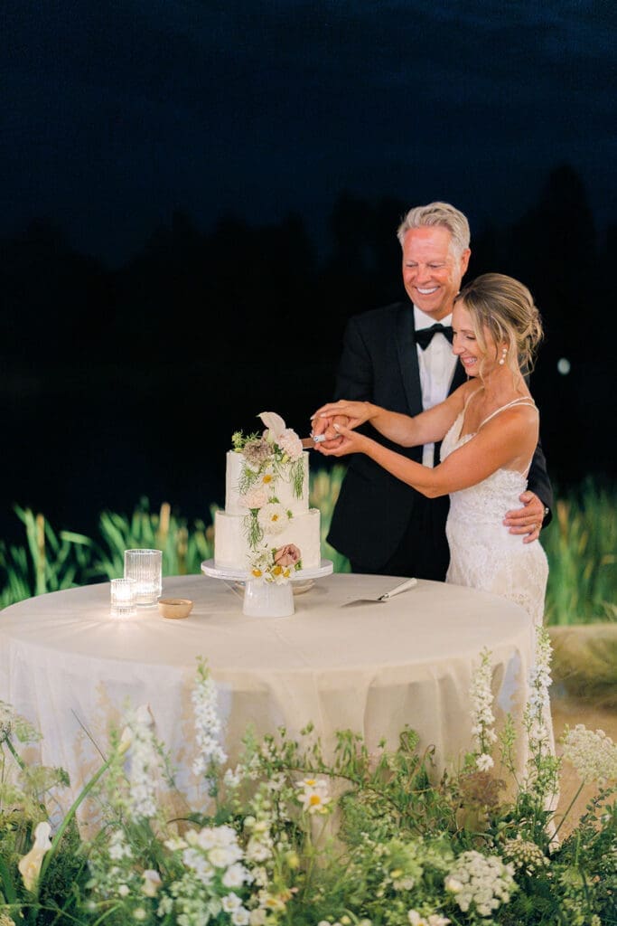 cute picture of the newlyweds cutting their wedding cake