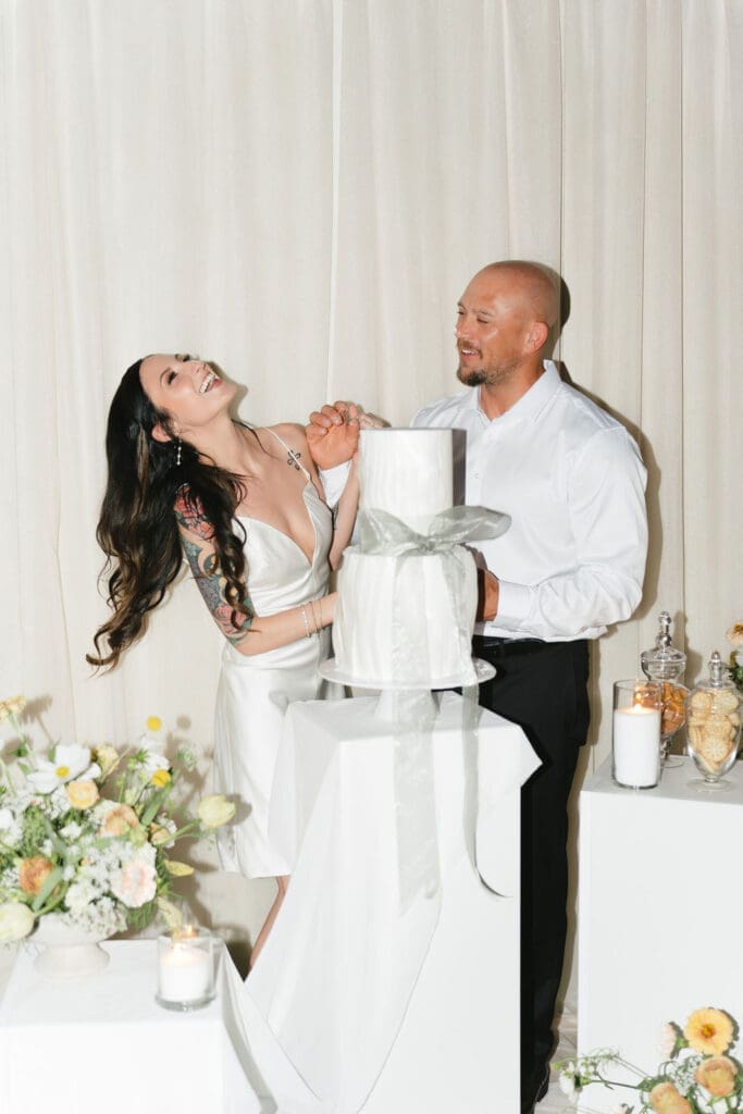 newlyweds trying their wedding cake